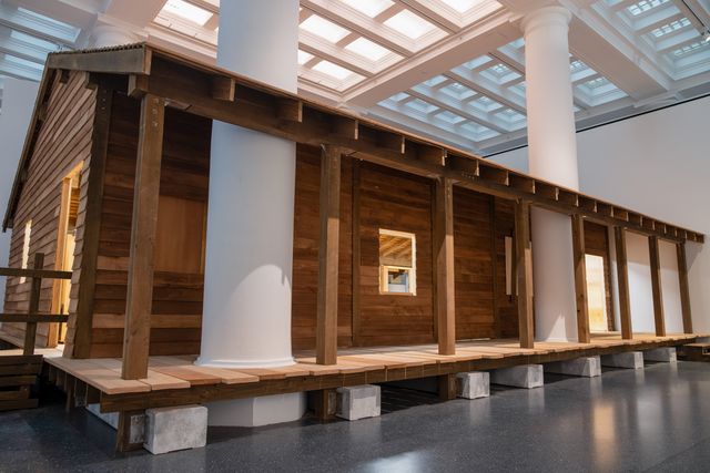 A large wooden enclosure inside a museum